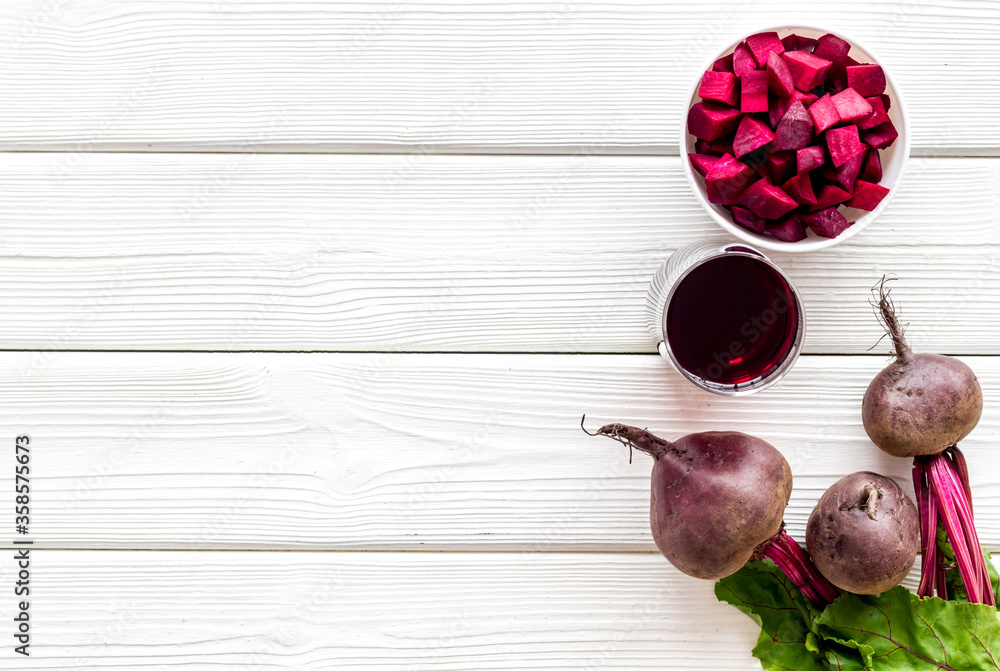 Sliced beet and juice on white table top view copy space