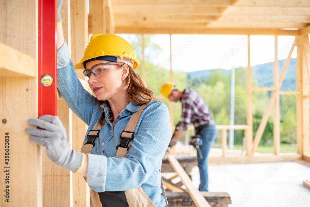 木框架房屋建筑工地女工使用水平工具