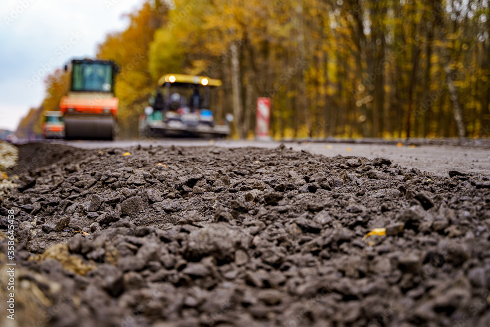 Heavy vibration roller at asphalt pavement works. Road repairing. Selective focus.