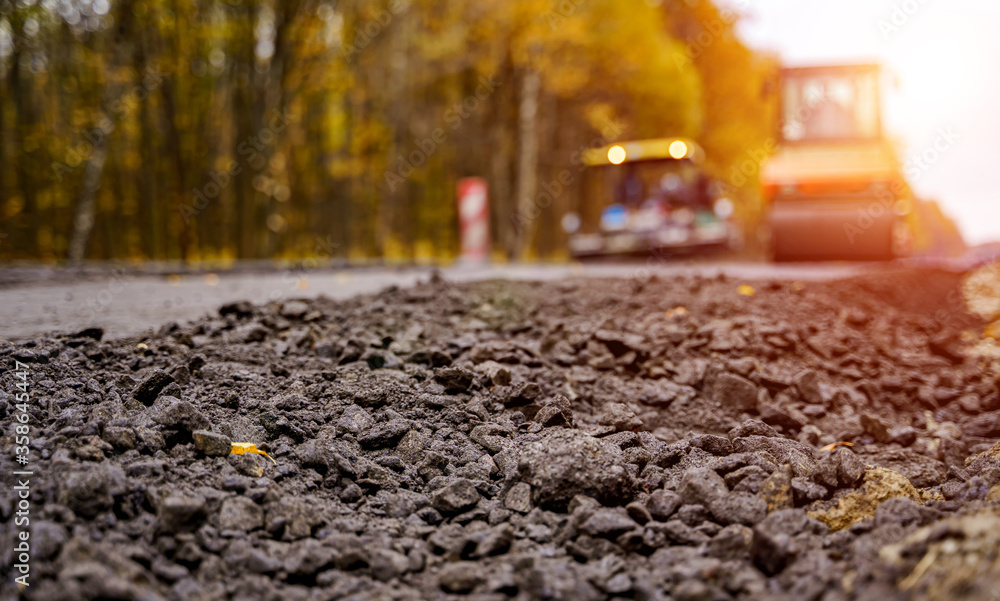 Road roller flattening new asphalt. Heavy vibration roller at work paving asphalt, road repairing. S