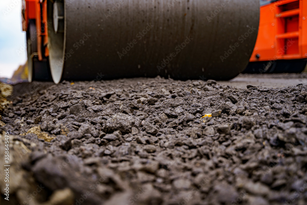 Close view on the road roller working on the new road construction site. Selective focus. Closeup