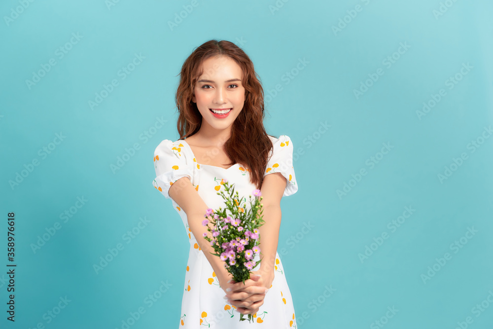 daisy flowers field holds a young woman in blue