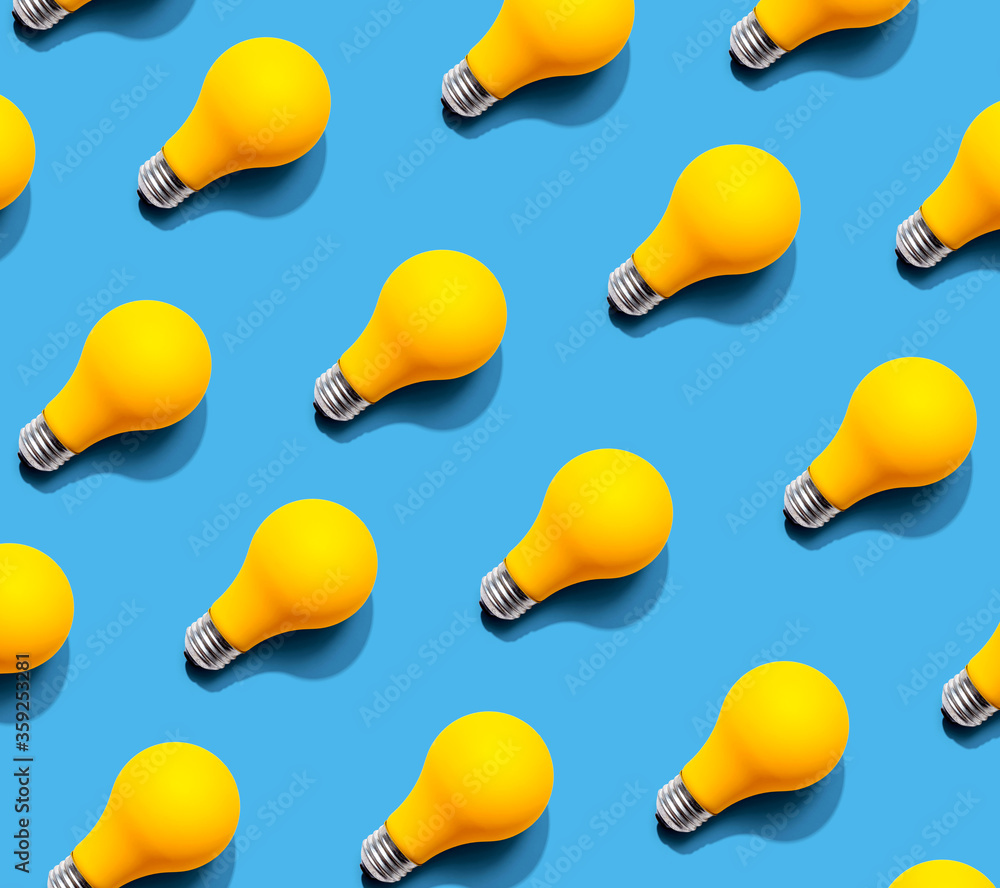 Yellow light bulb pattern with shadow - flat lay