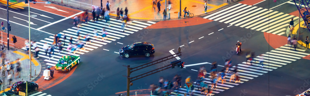 People and traffic cross the famous scramble intersection in Shibuya, Tokyo, Japan, one of the busie