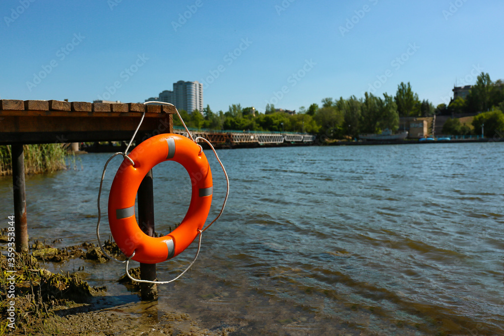 Lifebuoy ring hanging on berth outdoors