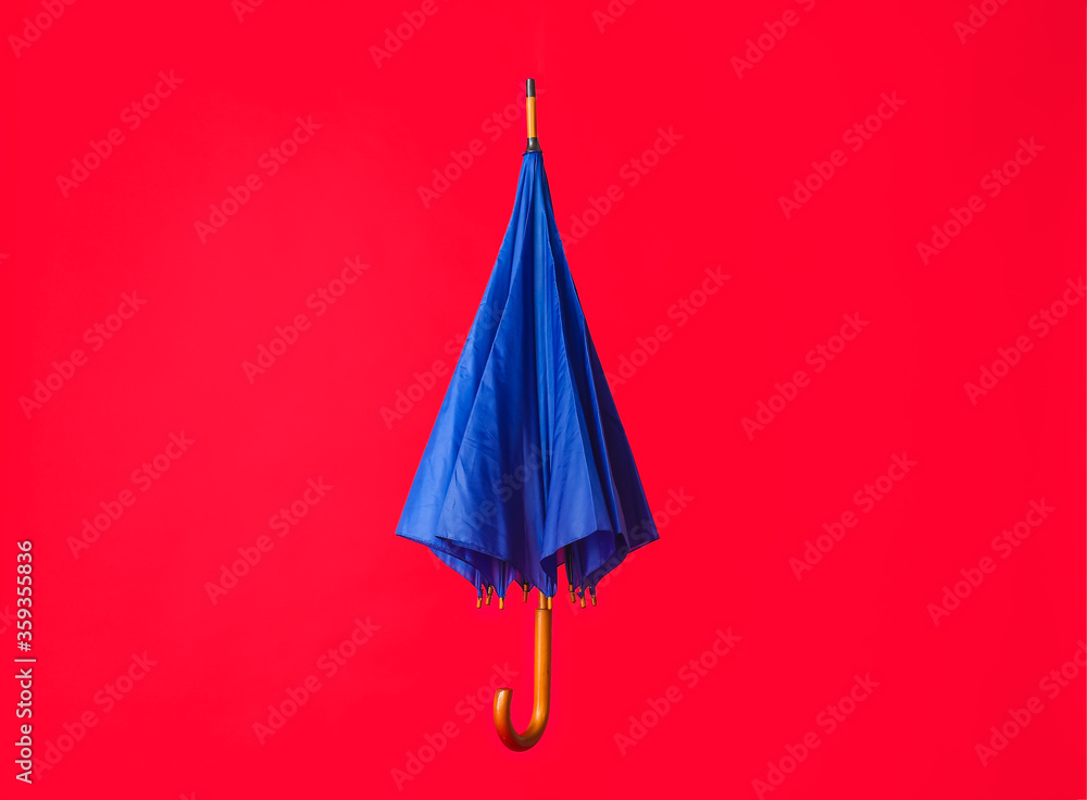 Stylish umbrella on color background