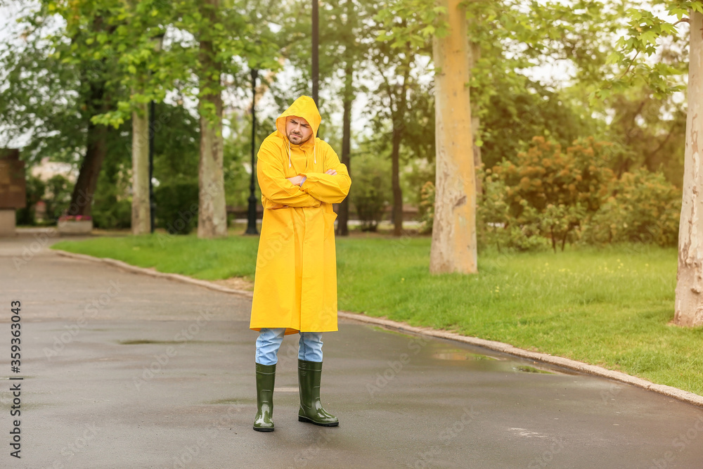 愤怒的年轻人在户外穿雨衣