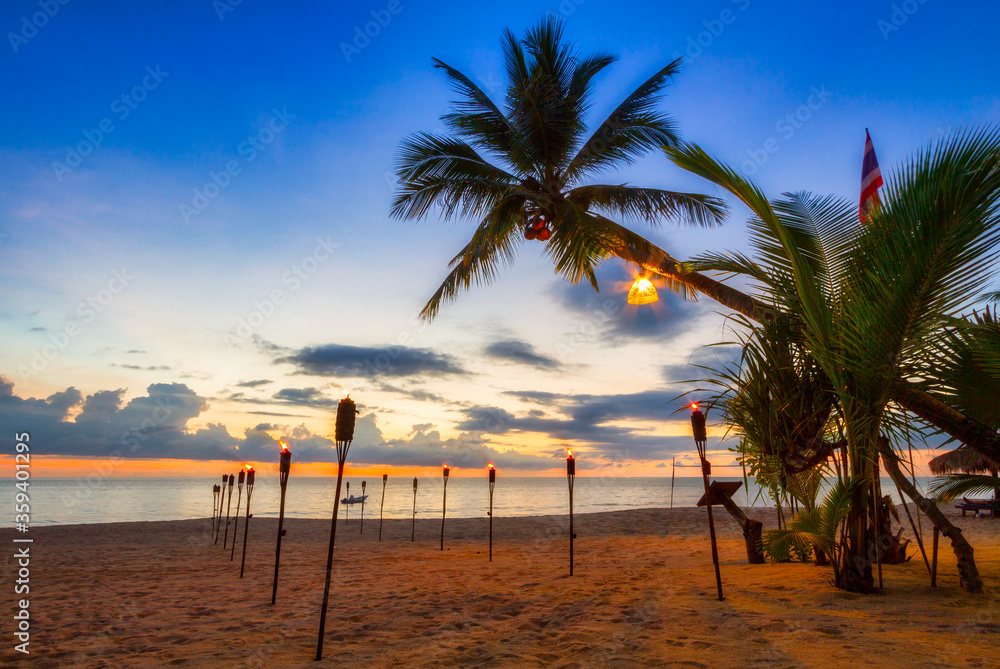 Beautiful sunset on the beach of Ko Kho Khao island with palm trees, Thailand