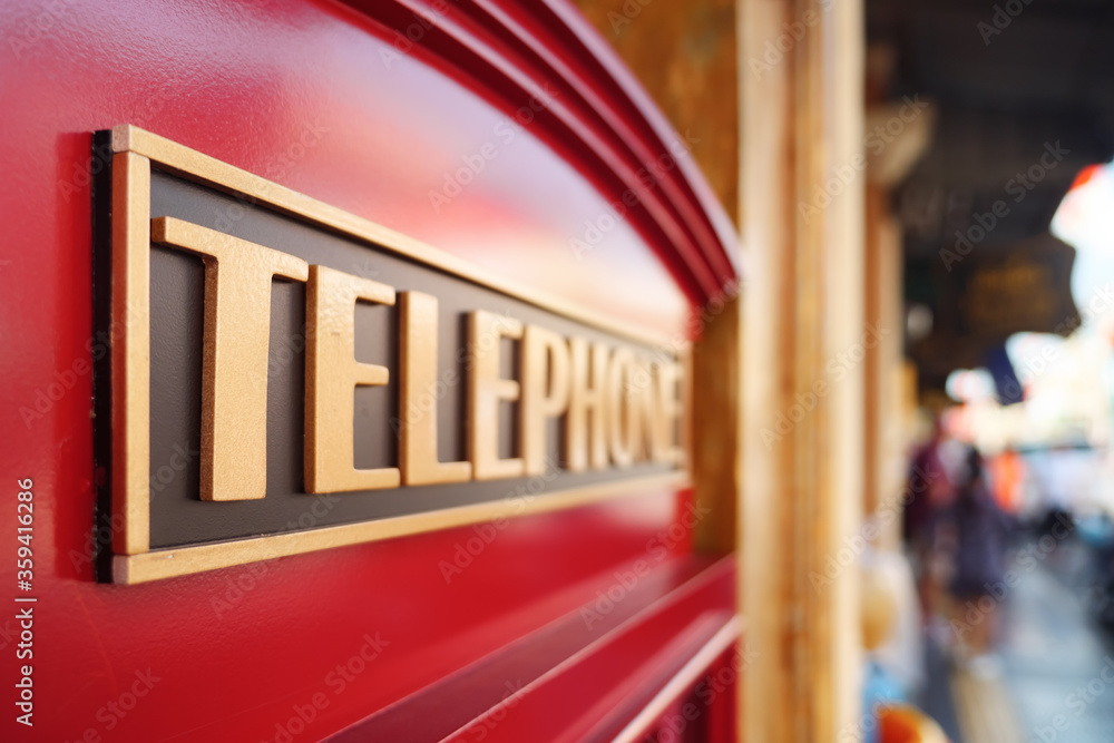 Close-up of an inscription on a red telephone box.