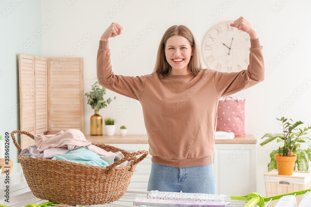 Young woman with clean laundry at home