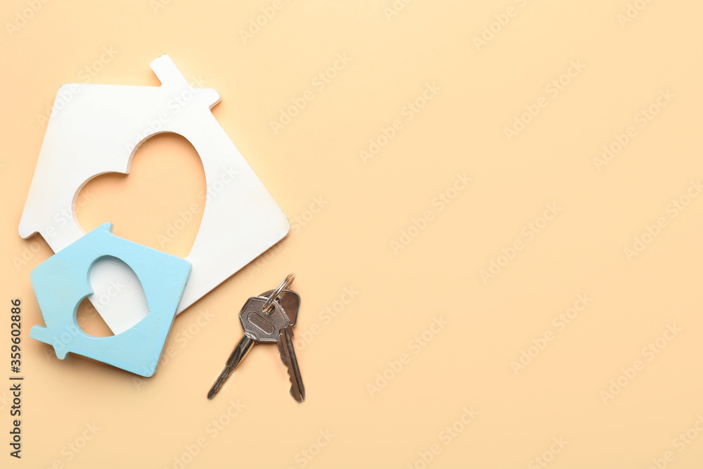 Keys from house on color background