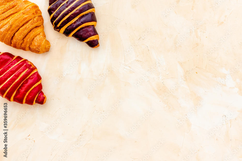 Set of croissants - chocolate, berry, classic - on stone table top view