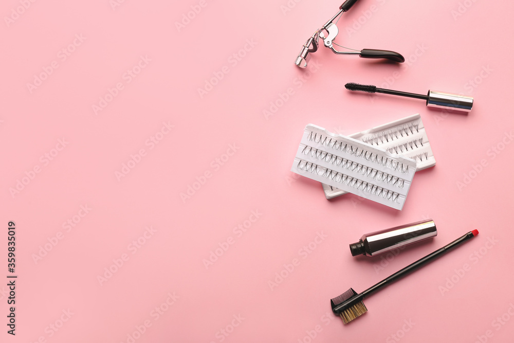 Mascara, eyelash extensions, brush and curler on color background