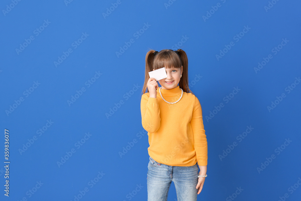 Little girl with business card on color background