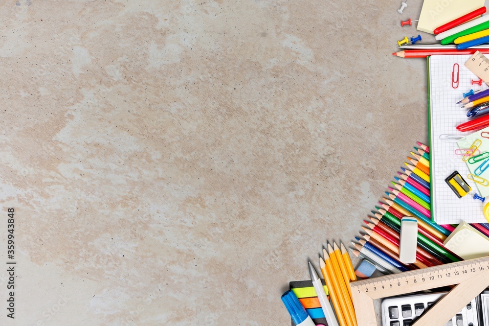 Assortment of colored school supplies on desk