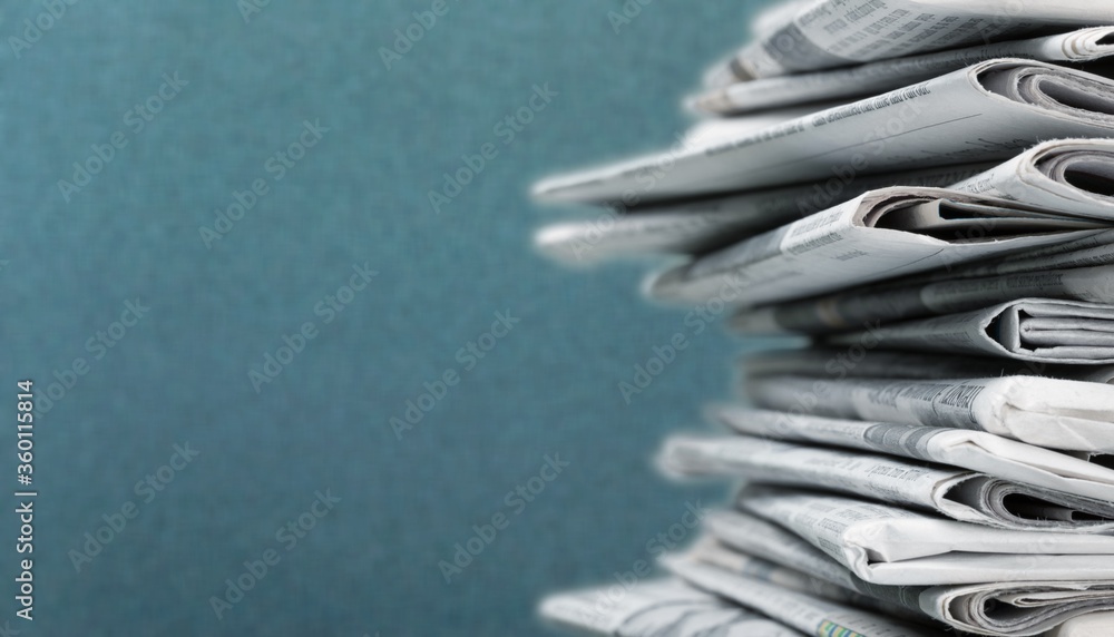 Pile of newspapers stacks on blur background