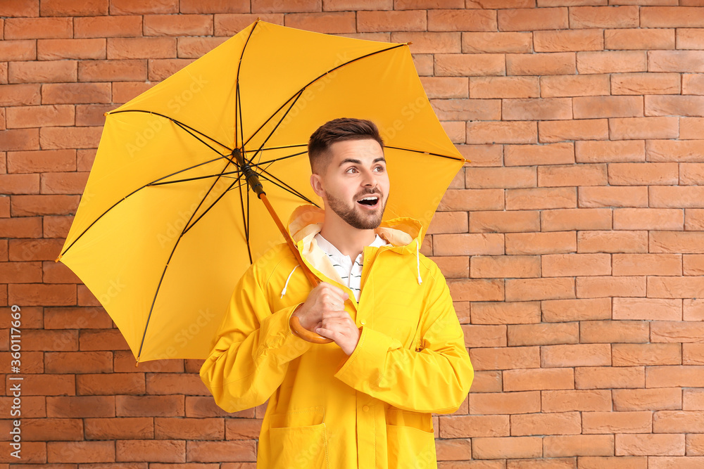 身穿雨衣、砖底带伞的年轻人