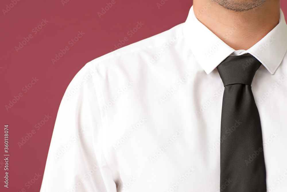 Young businessman in stylish shirt on color background, closeup