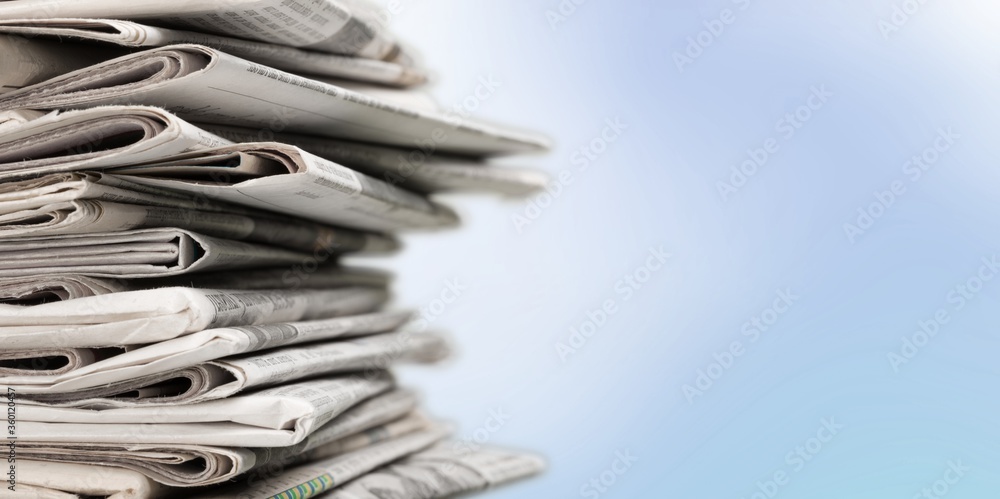 Pile of newspapers stacks on blur background