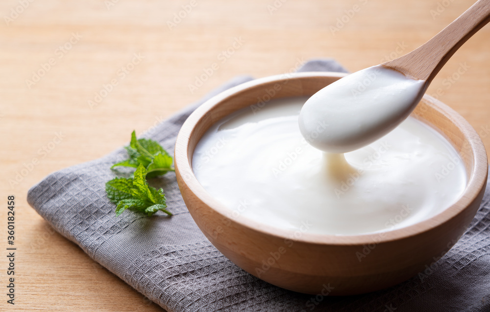 Yogurt on a wooden background