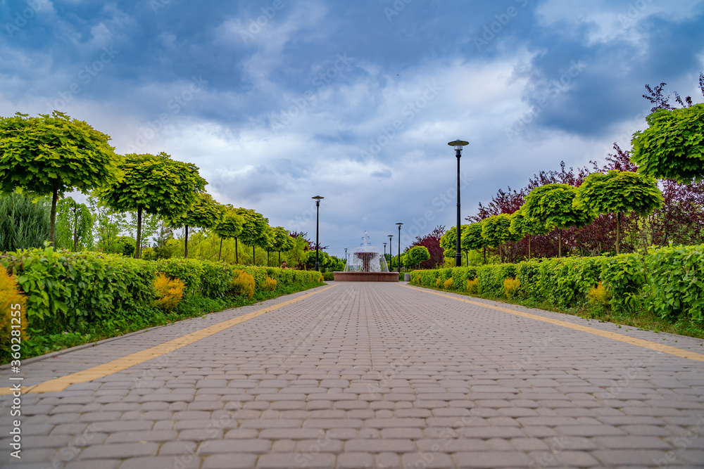 Selective view on a road to the urban house. Modern landscape. Townhouse`s district.