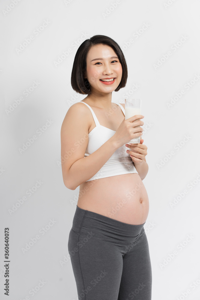 Pregnancy and calcium. Happy Pregnant Woman Holding Glass Of Milk Smiling At Camera