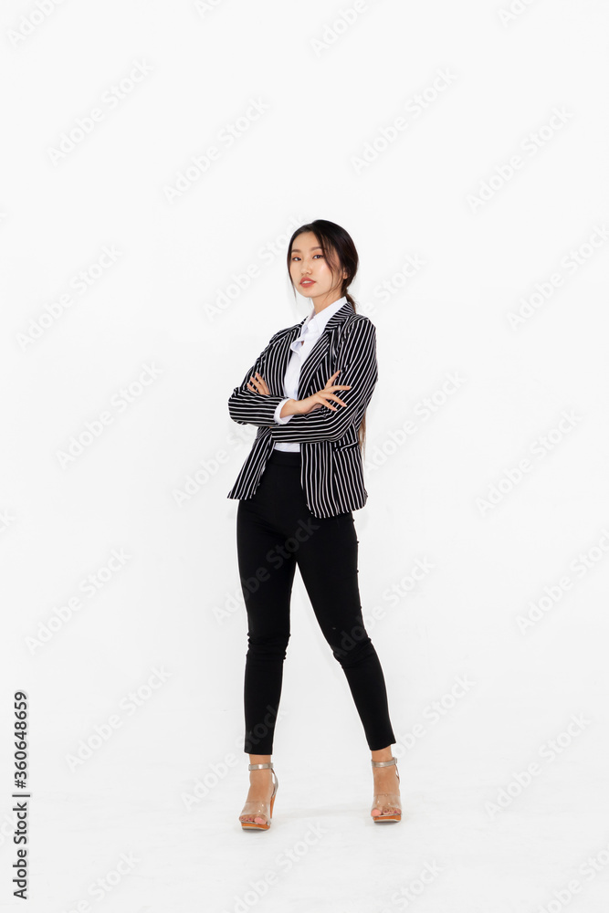 Asian woman full body portrait on white background wearing formal business suit .