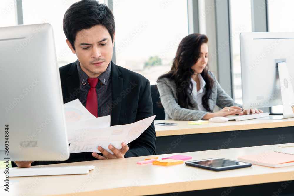 Business people working at table in modern office room while analyzing financial data report .