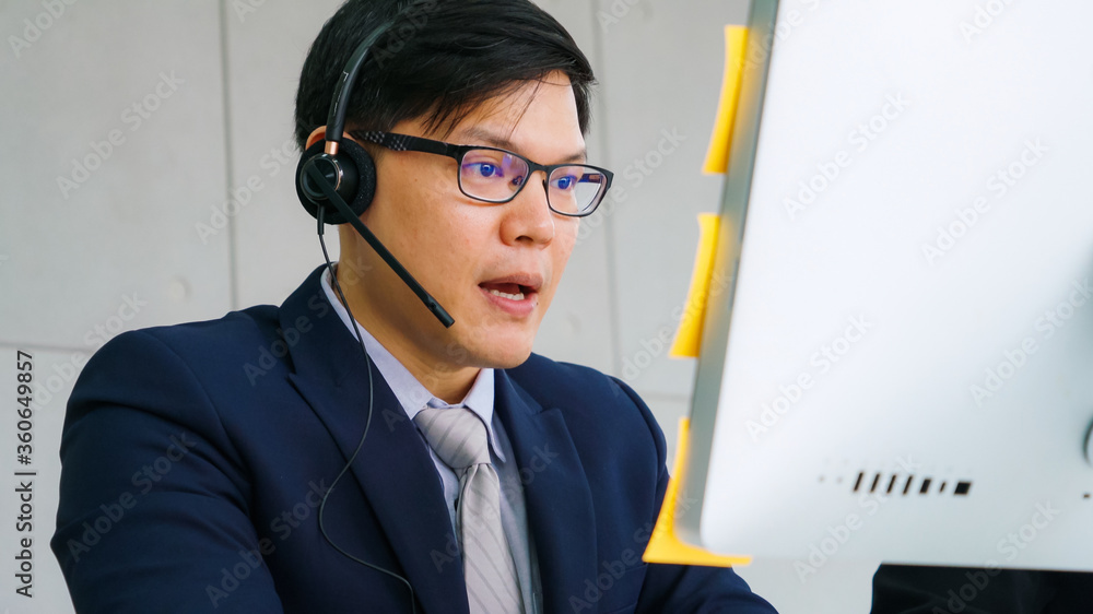 Business people wearing headset working in office to support remote customer or colleague. Call cent