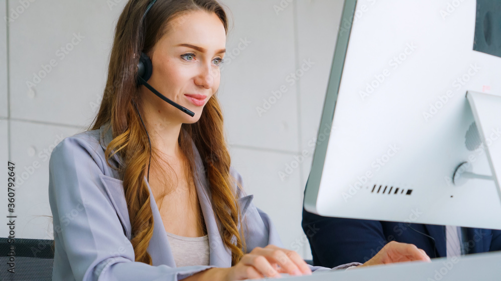 Business people wearing headset working in office to support remote customer or colleague. Call cent