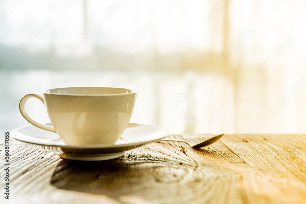 A white coffee mug on a wooden office desk