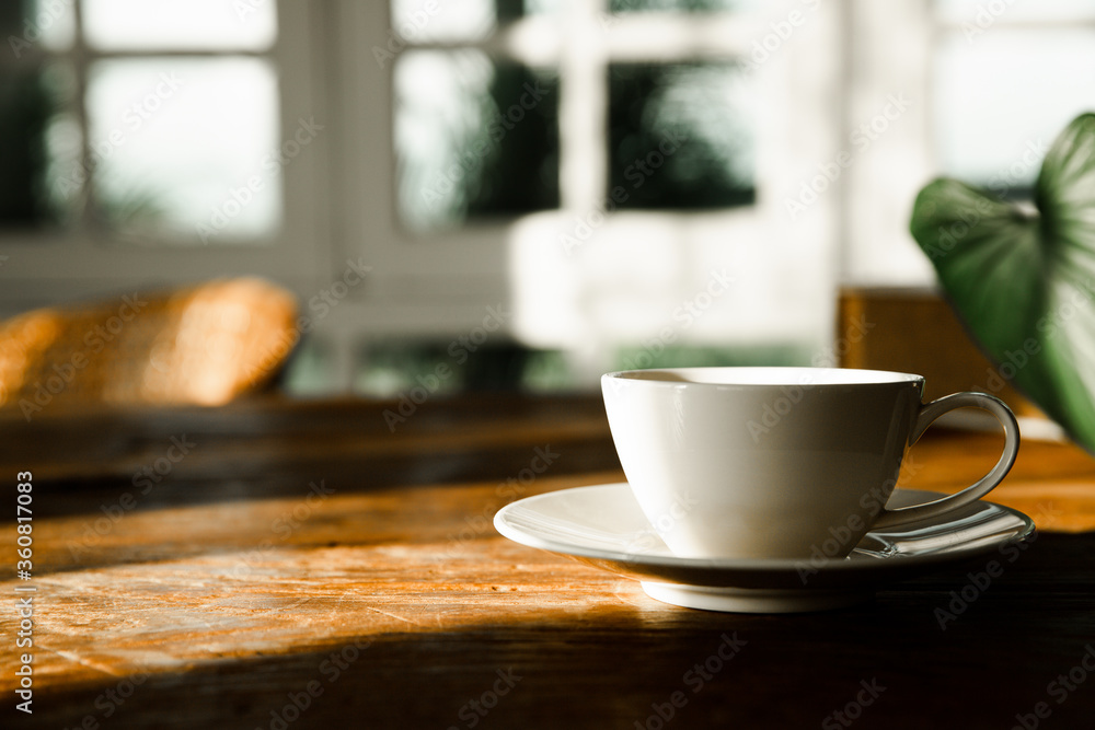 A white coffee mug on a wooden office desk