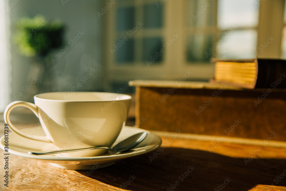 A white coffee mug on a wooden office desk