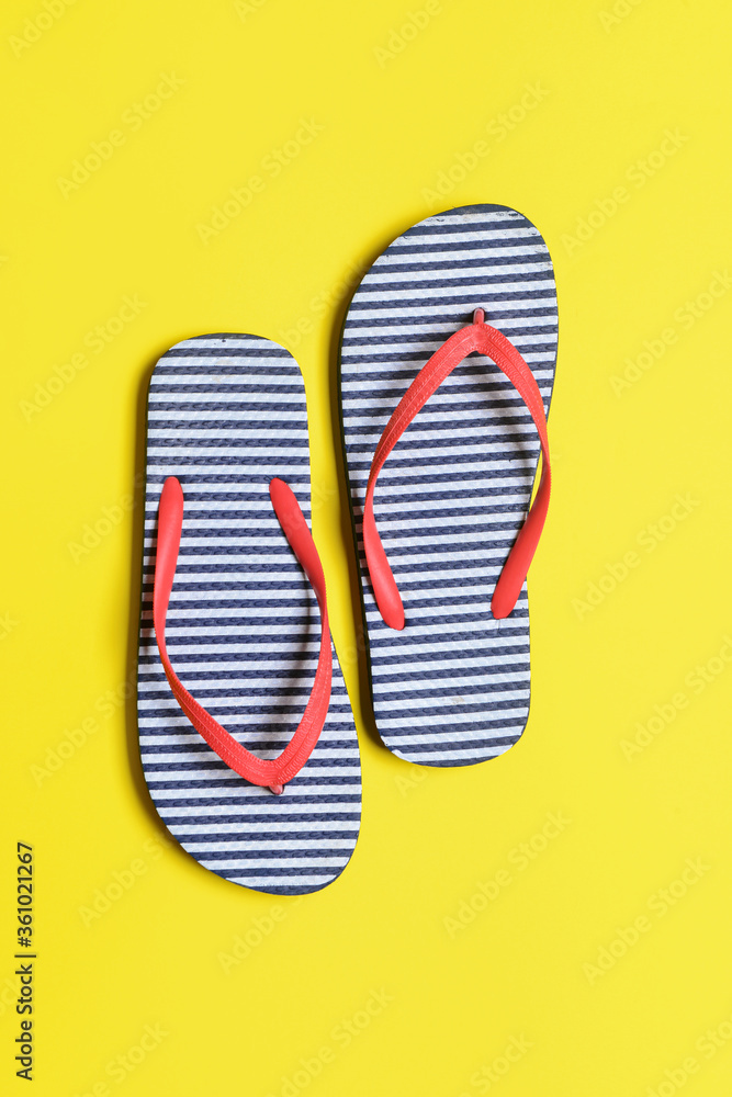 Stylish flip-flops on color background