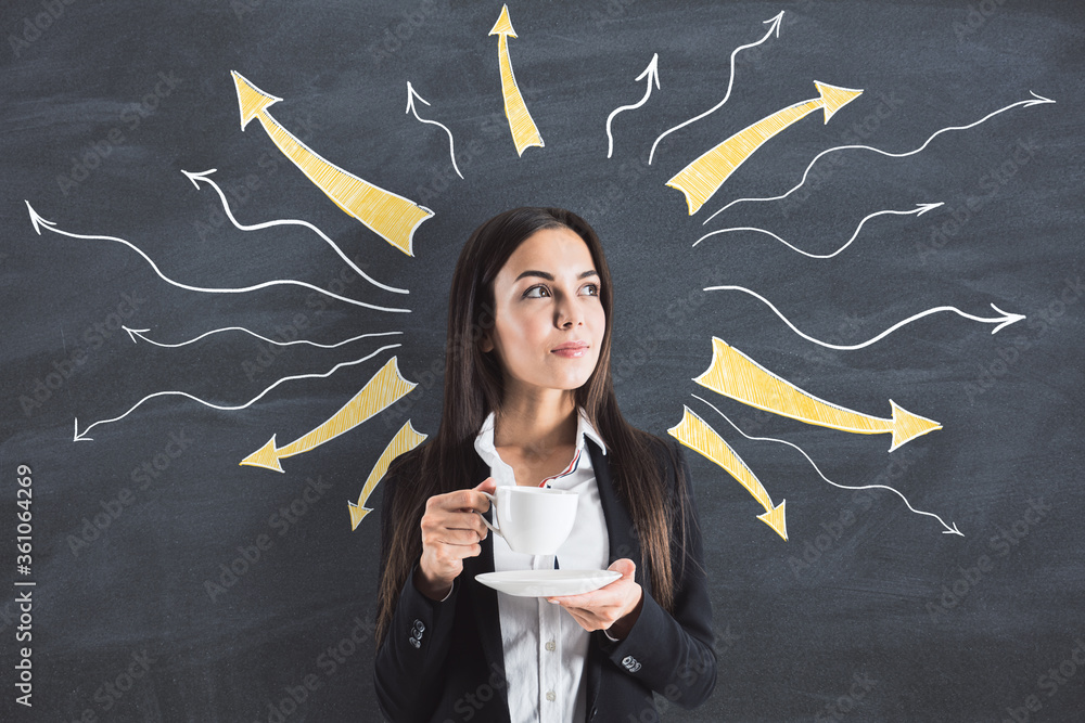 Young businesswoman holding coffeу cup with drawn arrows over her head