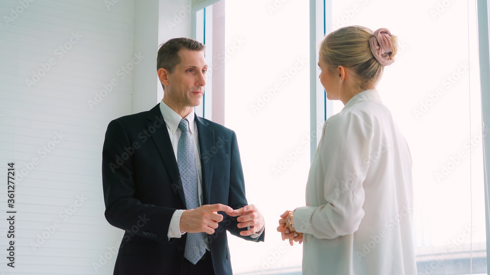 Two business people talk project strategy at office meeting room. Businessman discuss project planni