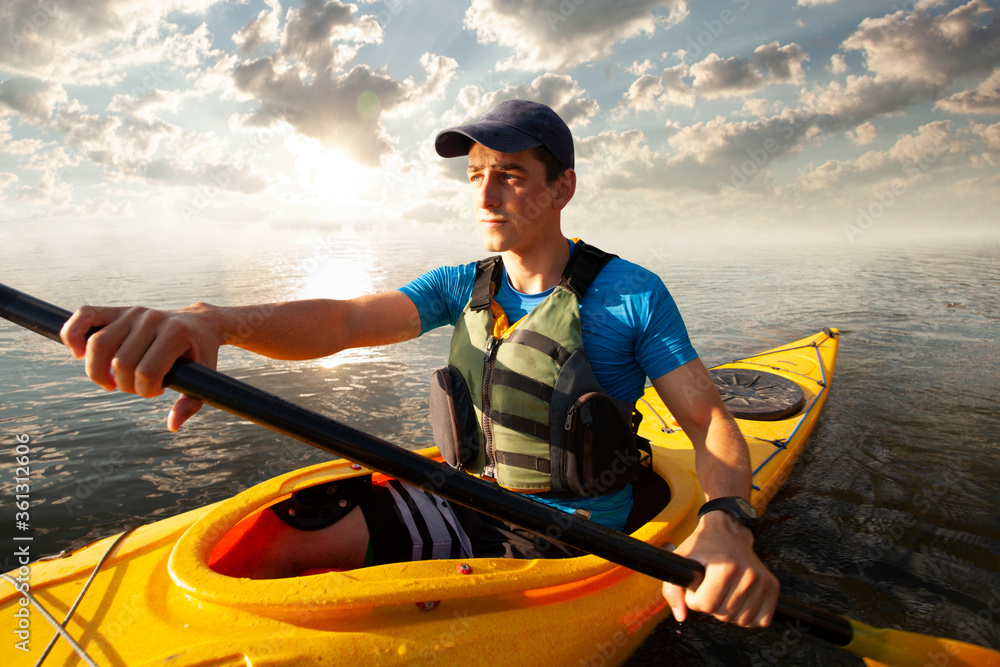 Kayaking. Man paddling a kayak. Canoeing, paddling.