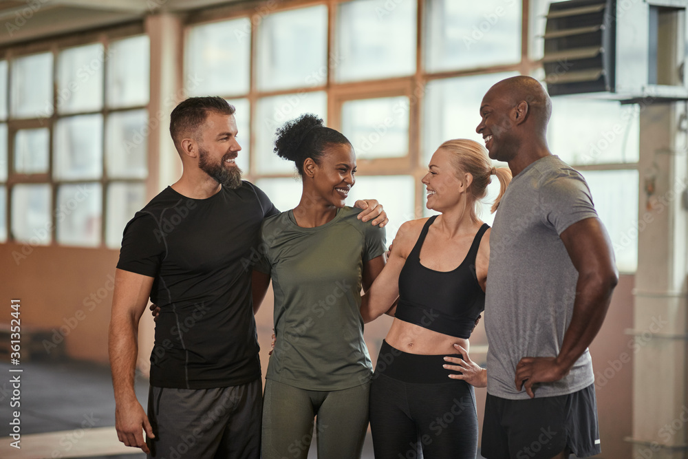 Diverse friends laughing together after working out a the gym