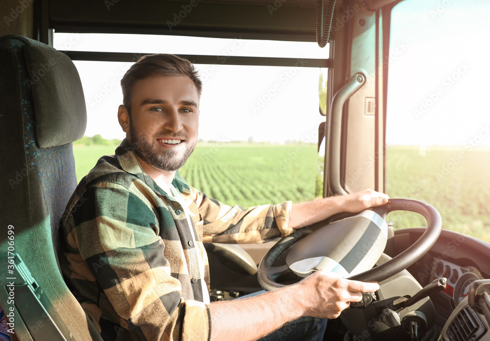 Young man driving modern truck