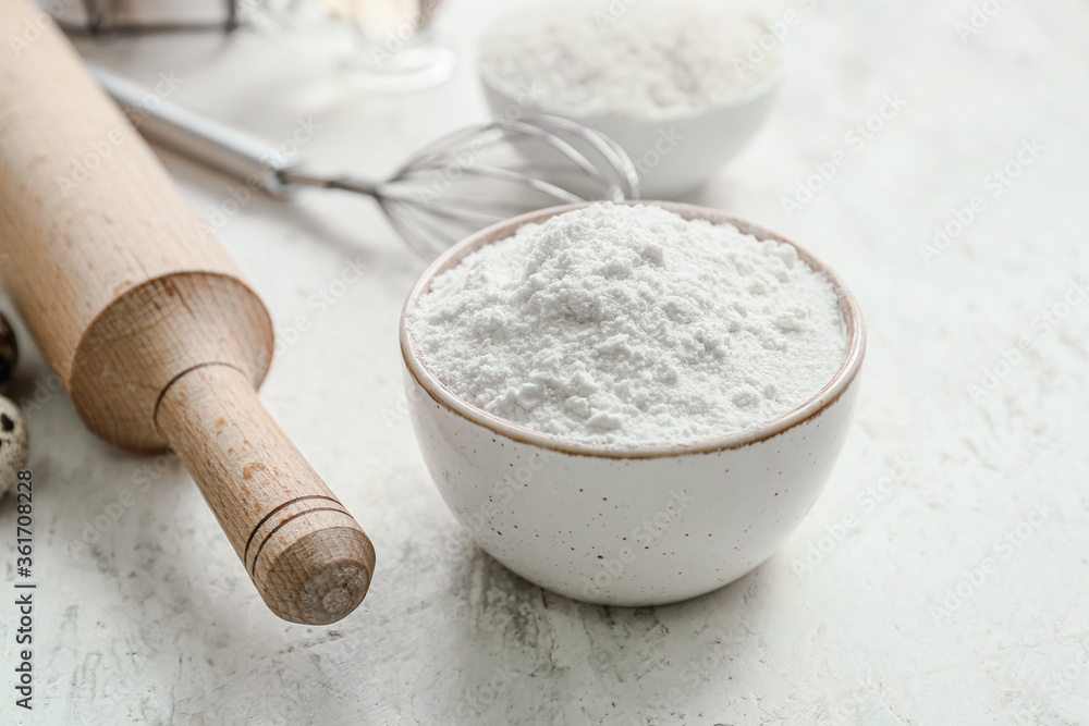 Bowl with rice flour on white table