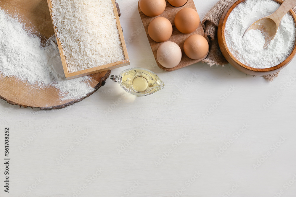 Bowl with rice flour and products on table