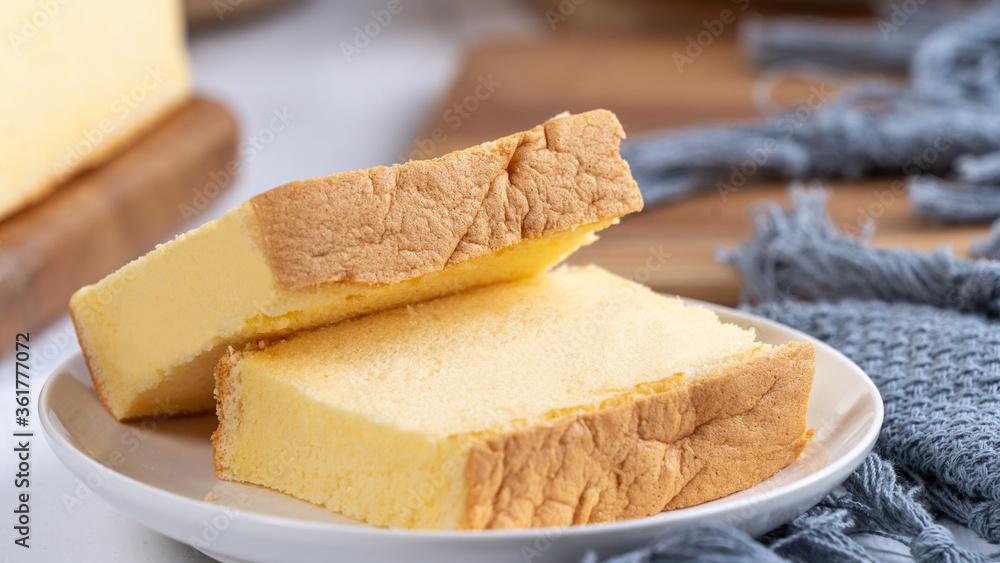 Plain classic Taiwanese traditional sponge cake (Taiwanese castella kasutera) on a wooden tray backg