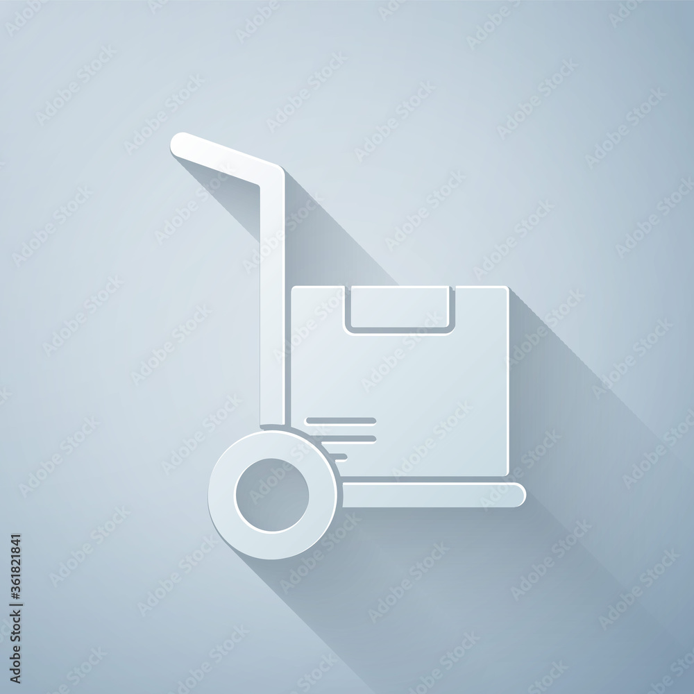 Paper cut Hand truck and boxes icon isolated on grey background. Dolly symbol. Paper art style. Vect