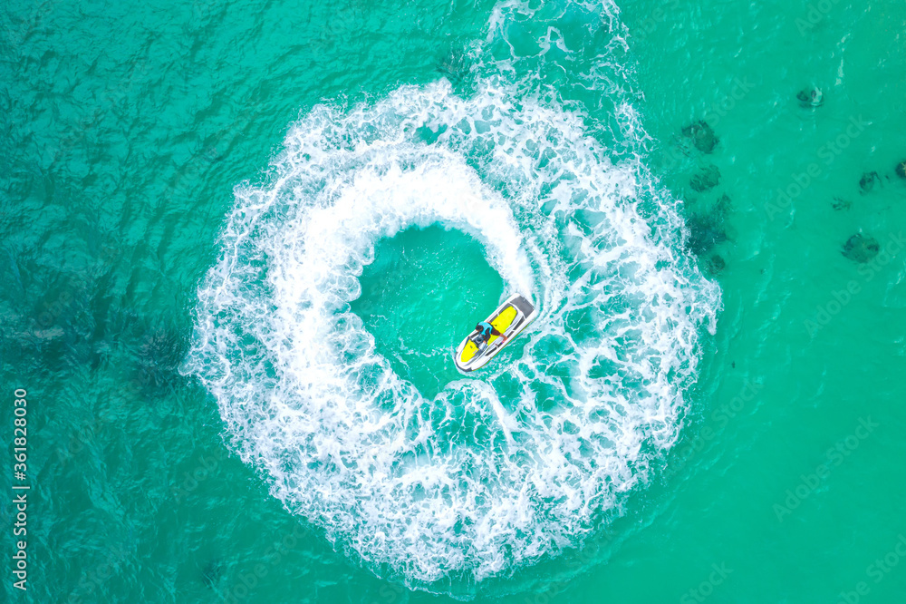 People are playing a jet ski in the sea.Aerial view. Top view.amazing nature background.The color of