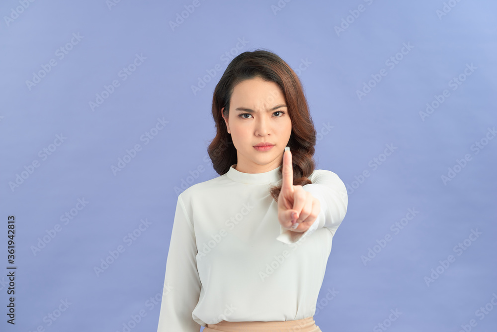 Serious girl raising finger up saying oh no you did not do that purple background