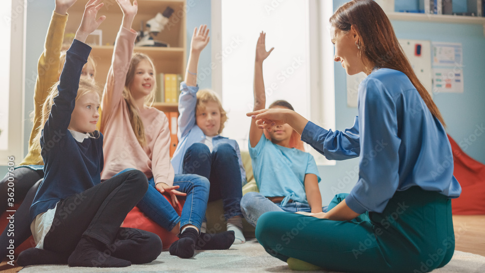 Elementary School Creativity Class: Children Sitting on the Carpet while Teacher Explains Lesson and