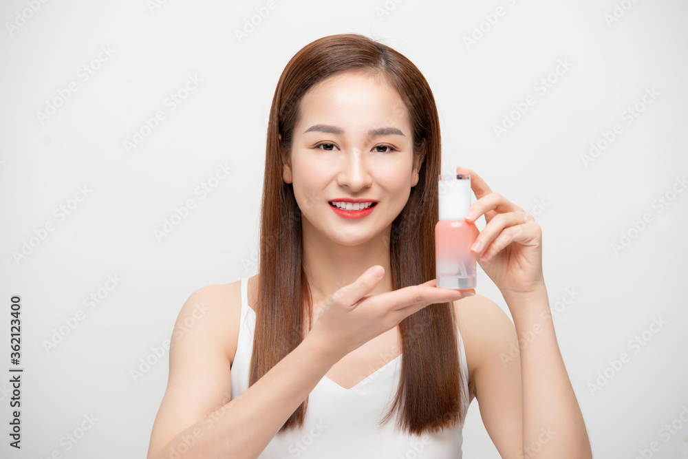 Beautiful Young Asian Woman with short hair Holding cosmetic product with healthy Clean and Fresh sk