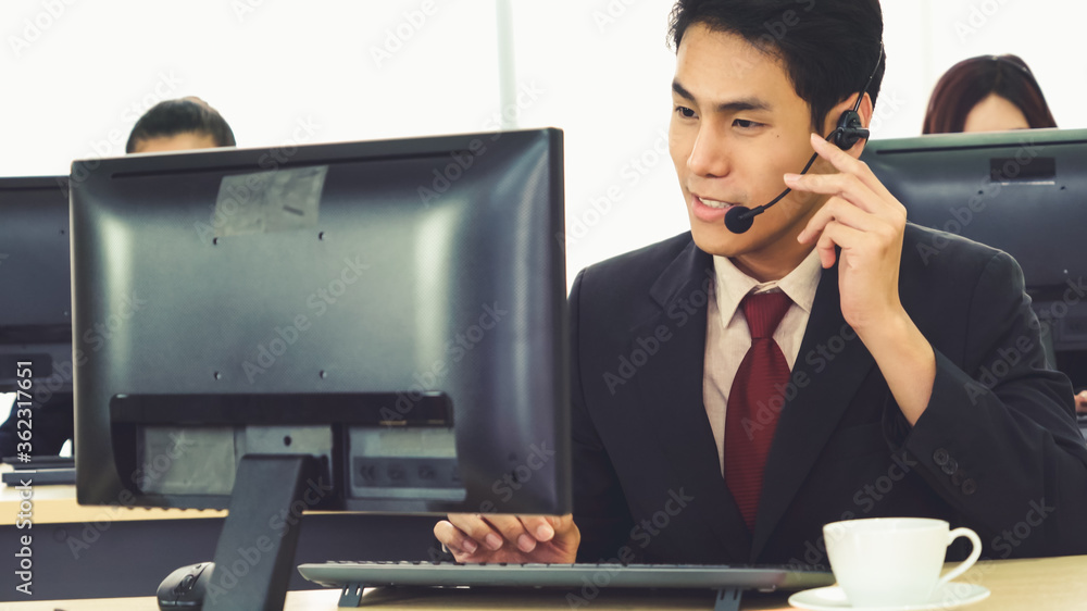 Business people wearing headset working in office to support remote customer or colleague. Call cent