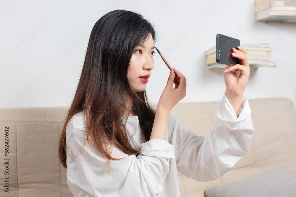 Asian beauty make up on mobile phone screen

