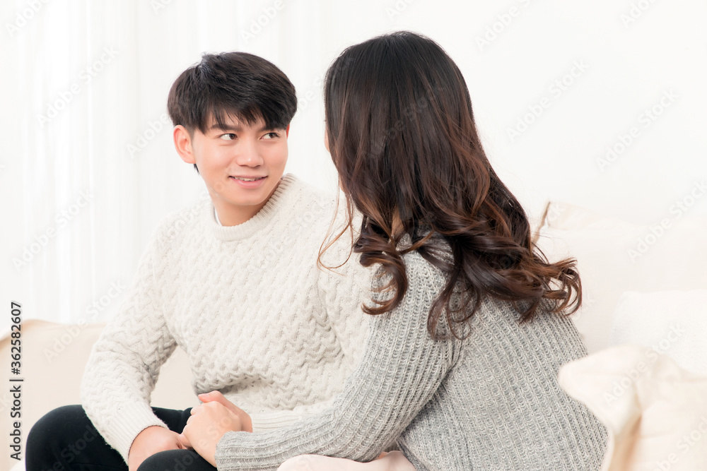 In winter, a pair of young Asian lovers sit on the sofa. Dont get angry

